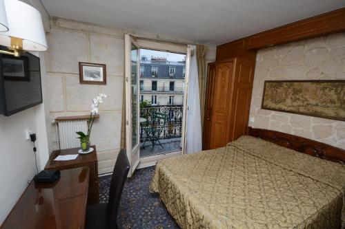 a hotel room with a bed and a window at Familia Hotel in Paris