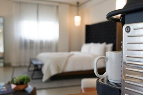 a hotel room with a bed and a coffee cup at Hotel G San Francisco in San Francisco