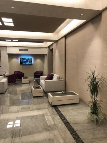 a living room with a couch and a tv at Hotel Olimpia in Imola