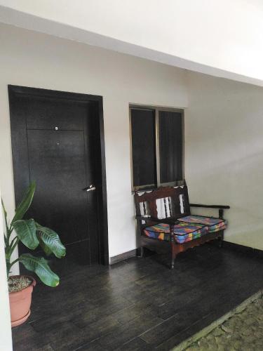 an empty room with a chair and a door at Hotel Sevilla Palenque in Palenque