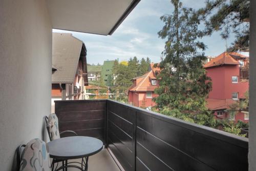 a balcony with a table and chairs and a view at Vila Bjanka in Zlatibor
