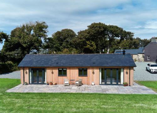 a small house with a patio in a yard at The Cabin in Haverfordwest