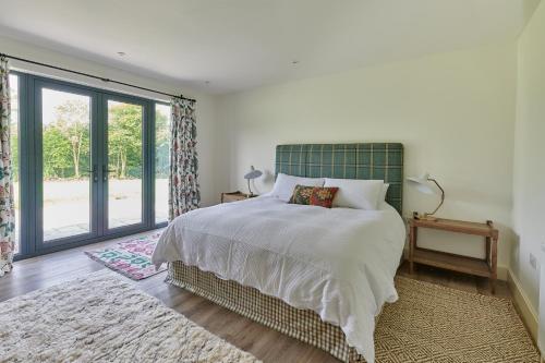 a bedroom with a bed and a large window at The Cabin in Haverfordwest
