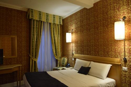 a hotel room with a bed and a window at Hotel dei Quiriti in Rome