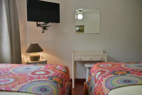 a bedroom with a bed and a tv on the wall at Hotel Zapata in Boca Chica