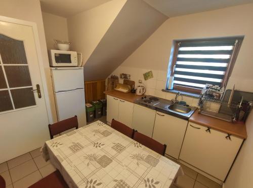 a small kitchen with a table and a microwave at Koniczynka in Ściegny