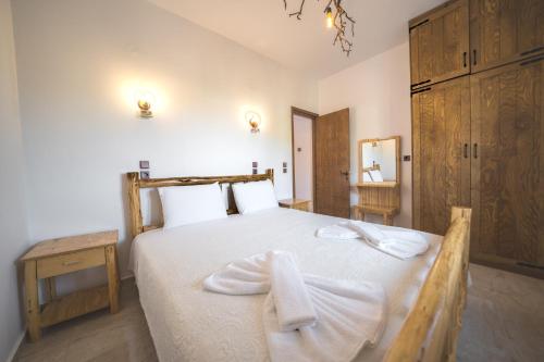 a bedroom with a bed with towels on it at Estia in Plátanos