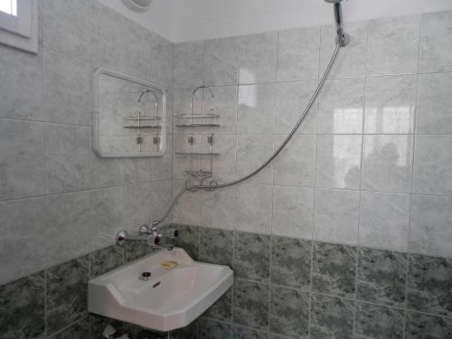 a bathroom with a sink and a shower at Къща Рачеви in Tryavna