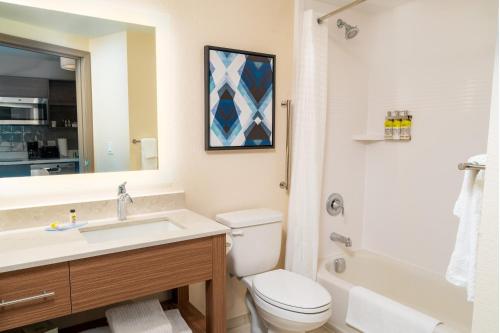 a bathroom with a toilet and a sink and a shower at Candlewood Suites - Las Vegas - E Tropicana by IHG in Las Vegas