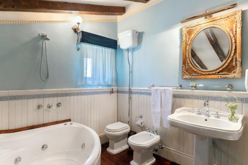 a bathroom with a tub and a toilet and a sink at Relais Briuccia e Ristorante Capitolo Primo in Montallegro