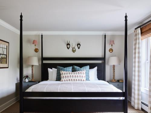 a bedroom with a black and white bed with pillows at The White Barn Inn & Spa, Auberge Collection in Kennebunk