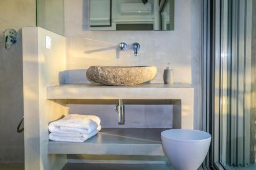 a bathroom with a sink and a toilet at Thalasses Villas Skiathos in Skiathos Town