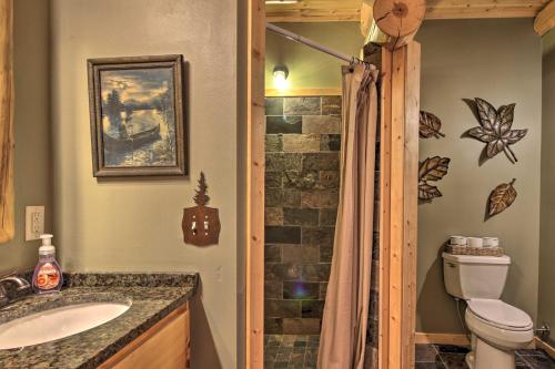 a bathroom with a toilet and a sink and a shower at Expansive Ruth Lake Home with Dock, Fire Pit and Beach in Emily