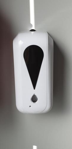 a white object with a black triangle on a wall at Apartment Villa Ksenija in Ostend