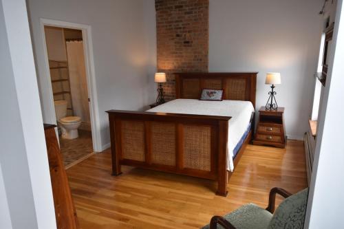 a bedroom with a bed and a bathroom at Riverhouse Extended Stay Apartment in Jersey City