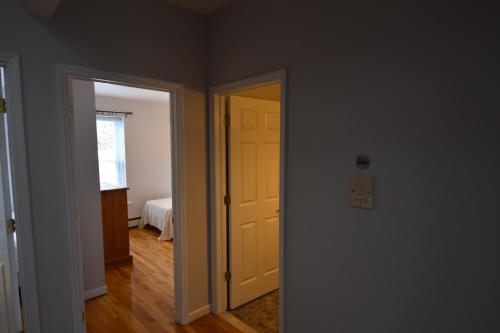 a hallway with a yellow door and a room at Riverhouse Extended Stay Apartment in Jersey City