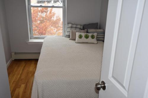 a bed in a room with a window at Riverhouse Extended Stay Apartment in Jersey City
