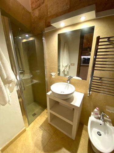 a bathroom with a sink and a shower and a toilet at San Domenico Suite in Martano