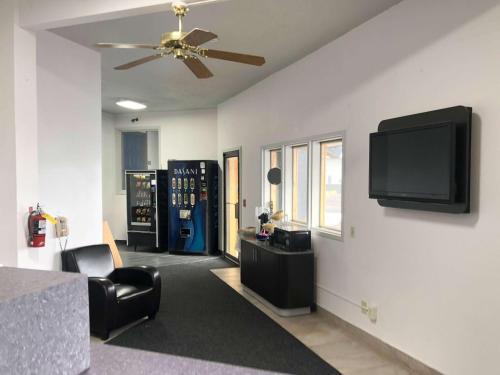 a living room with a flat screen tv on a wall at Motel 6 Missoula, Mt - Wye - Travel Plaza in Missoula