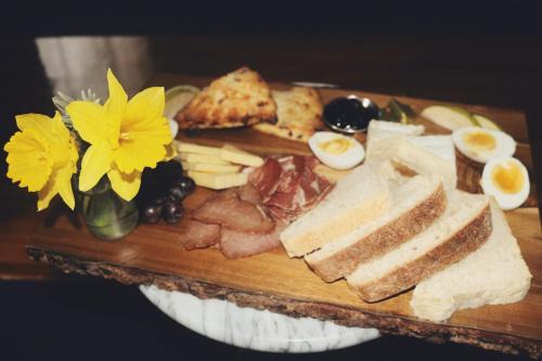 a plate of food with bread and eggs and cheese at Shelburne Hotel in Seaview