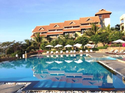 a swimming pool in front of a resort at Romana Resort & Spa in Mui Ne