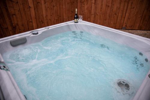 a jacuzzi tub with a bottle of beer in it at South Causey Inn in Stanley