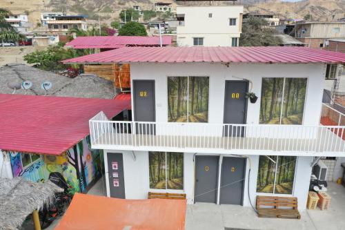 a small white house with a red roof at Soga Hostal in Santa Marianita