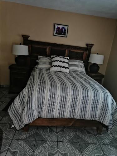 a bed with two pillows on it in a bedroom at Posada Las Reynas in Mineral de Pozos
