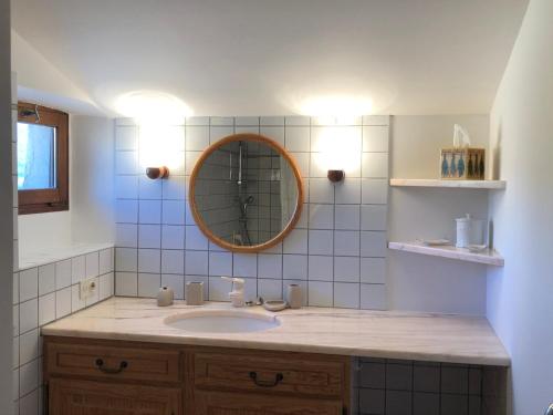 a bathroom with a sink and a mirror at Le Mas de Fanny in Faucon