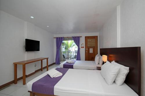 Postel nebo postele na pokoji v ubytování MR Holidays Hotel