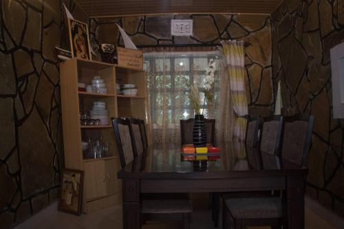 ein Esszimmer mit einem Tisch und 2 Stühlen in der Unterkunft Room in Bungalow - Reens Vacation Rental Home in Nakuru