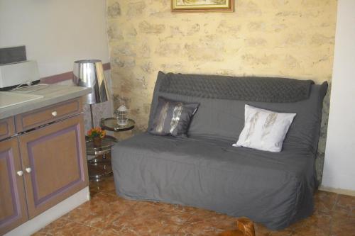 a bedroom with a bed with two pillows on it at Le Prunier Lou Mas Li Pitchoun in Gordes