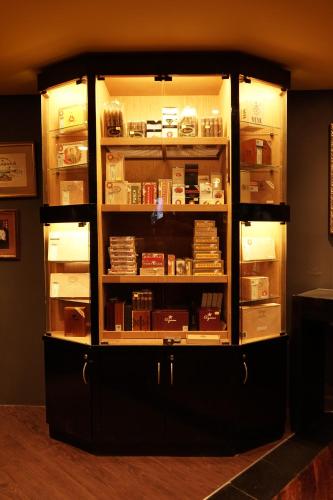 a large cabinet filled with lots of books at Shahzan Hotel Kuantan, Trademark Collection by Wyndham in Kuantan