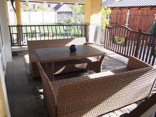 a wooden table and chairs on a patio at Penzion SLUNCE in Česká Lípa