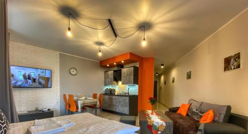 a living room with a couch and a dining room at Apartamenty Szóstka Wisła Kamienna in Wisła