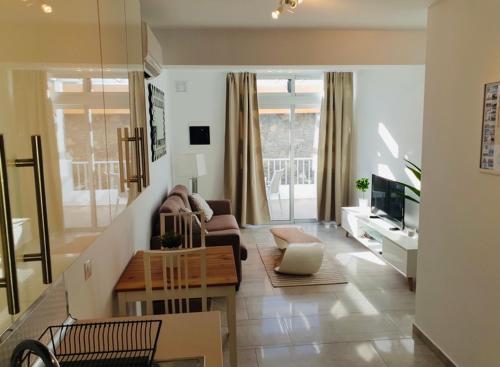 a living room with a couch and a table at Los Gracioseros in Puerto del Carmen