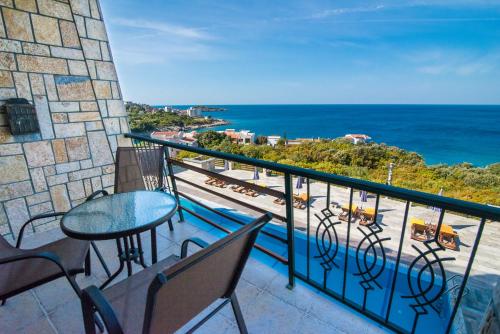 a balcony with a table and chairs and the ocean at Arabela 2 Apartments in Utjeha