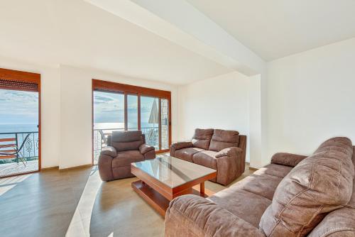 a living room with two couches and a coffee table at Arabela 2 Apartments in Utjeha