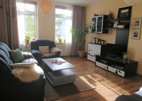 a living room with a couch and a coffee table at Ferienwohnung HARZgeNUSS in Wernigerode