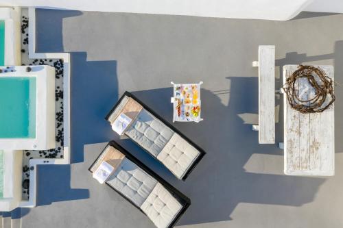 a table with three boxes on a wall at Santolia Art Suites in Oia