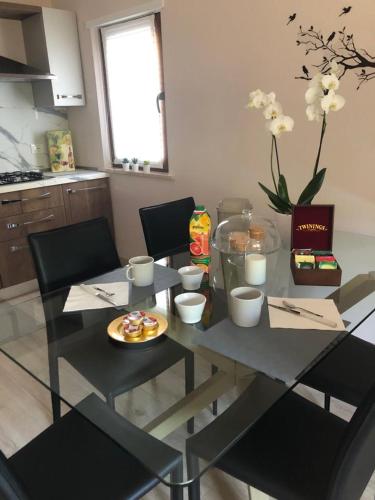 a dining room table with chairs and a tableasteryasteryasteryasteryasteryasteryastery at B&B Agli ulivi in Gemona del Friuli