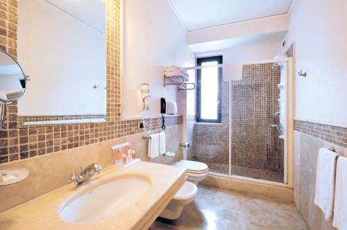 a bathroom with a sink and a toilet at Grand Hotel Paestum in Paestum