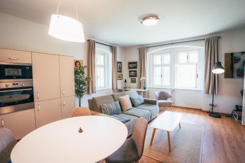 a living room with a couch and a table at Aparthotel & Wellness Knížecí cesta in Horní Planá