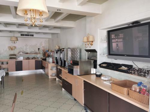 a large kitchen with a large flat screen tv on the wall at Hotel Alfonso VIII De Cuenca in Cuenca