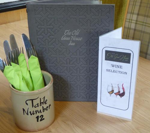 a cup of forks and knives and a wine subscription box at The Old Ginn House Inn in Great Clifton