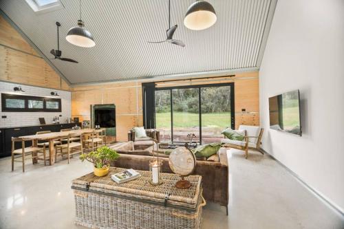 a living room with a couch and a table at 3BlackSHEDS in Whitfield