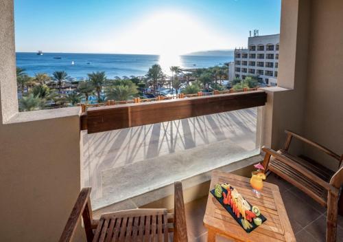 a balcony with a view of the beach and the ocean at InterContinental Aqaba by IHG in Aqaba