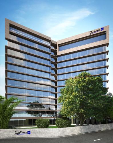 an architectural rendering of a tall office building at Radisson Blu Mumbai International Airport in Mumbai