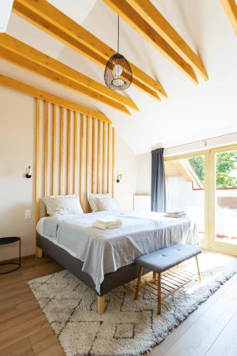 a bedroom with a bed and a large window at Lujza & Koriander in Vác