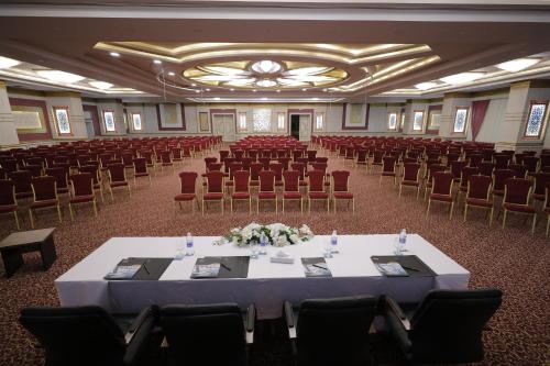 a large banquet hall with a table and chairs at Tolip Gardens Hotel in Cairo